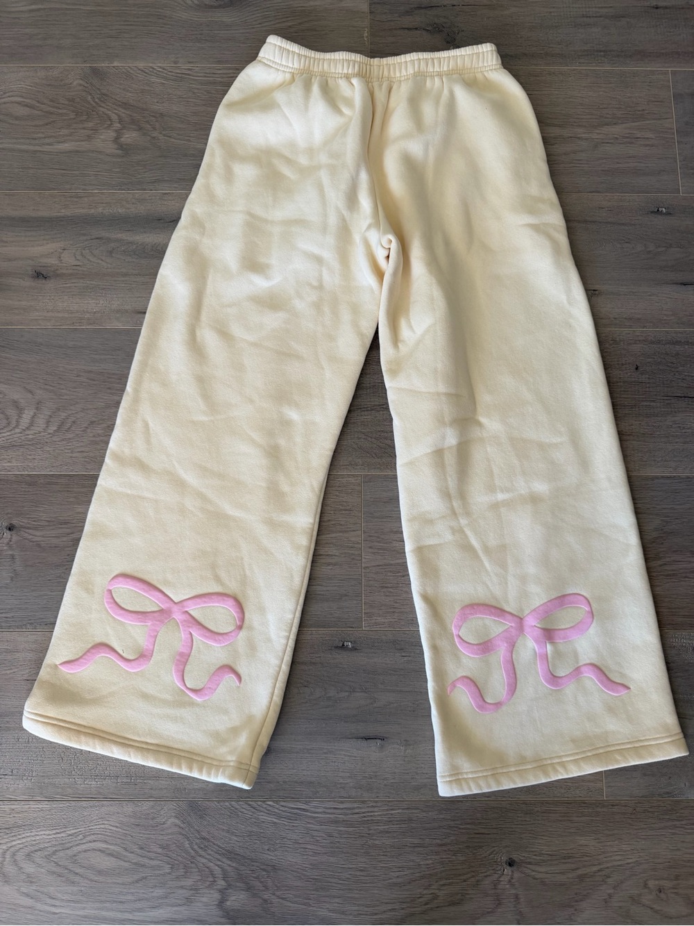 Edikted Cream Sweatpants with Pink Bow Accents